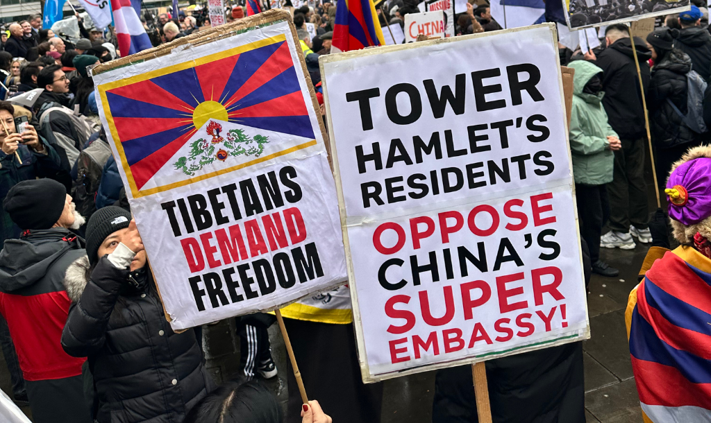 Protesters hold placards outside Royal Mint Court (planned embassy site). Placards read: "Tibetans demand freedom" and "Tower Hamlets' residents oppose China's super embassy!"