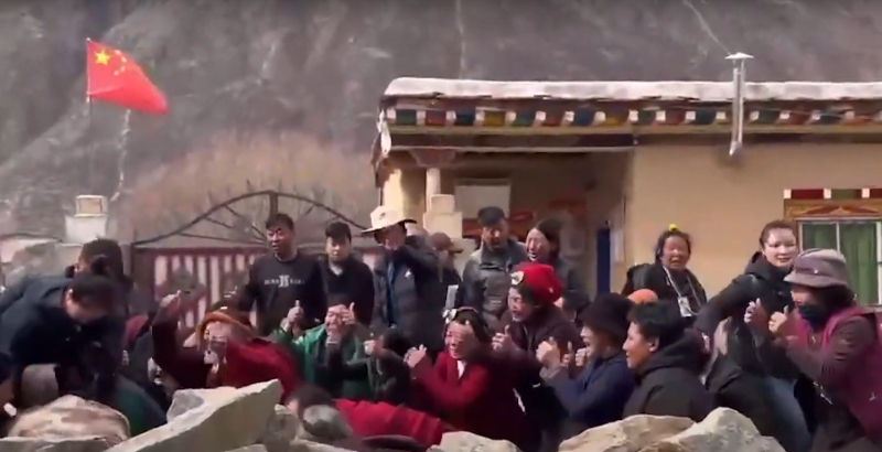 Tibetans show their thumbs in pleading to authorities, during protests in Dege County.