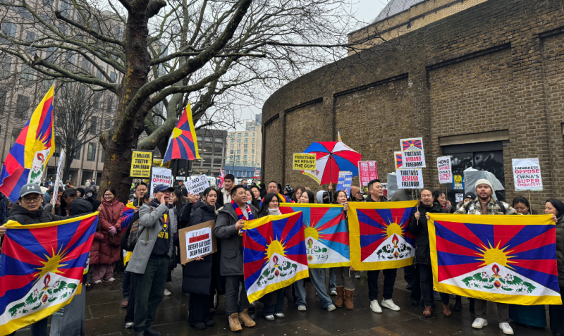 A group of protesters hold up Tibetan flags outside Royal Mint Court (the planned embassy site in Tower Hamlets)